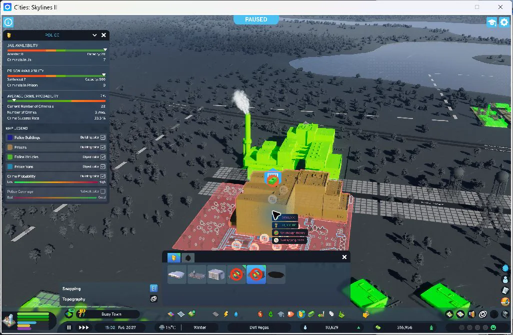 18:20 — The prison has been added across the service road from the incinerator; the overlay now shows 500 prison places and cash has fallen to ₡316,956. The placement tool is still active and shows a red overlapping duplicate preview. No second prison was built. This is the construction record, not a clean completed-building portrait.