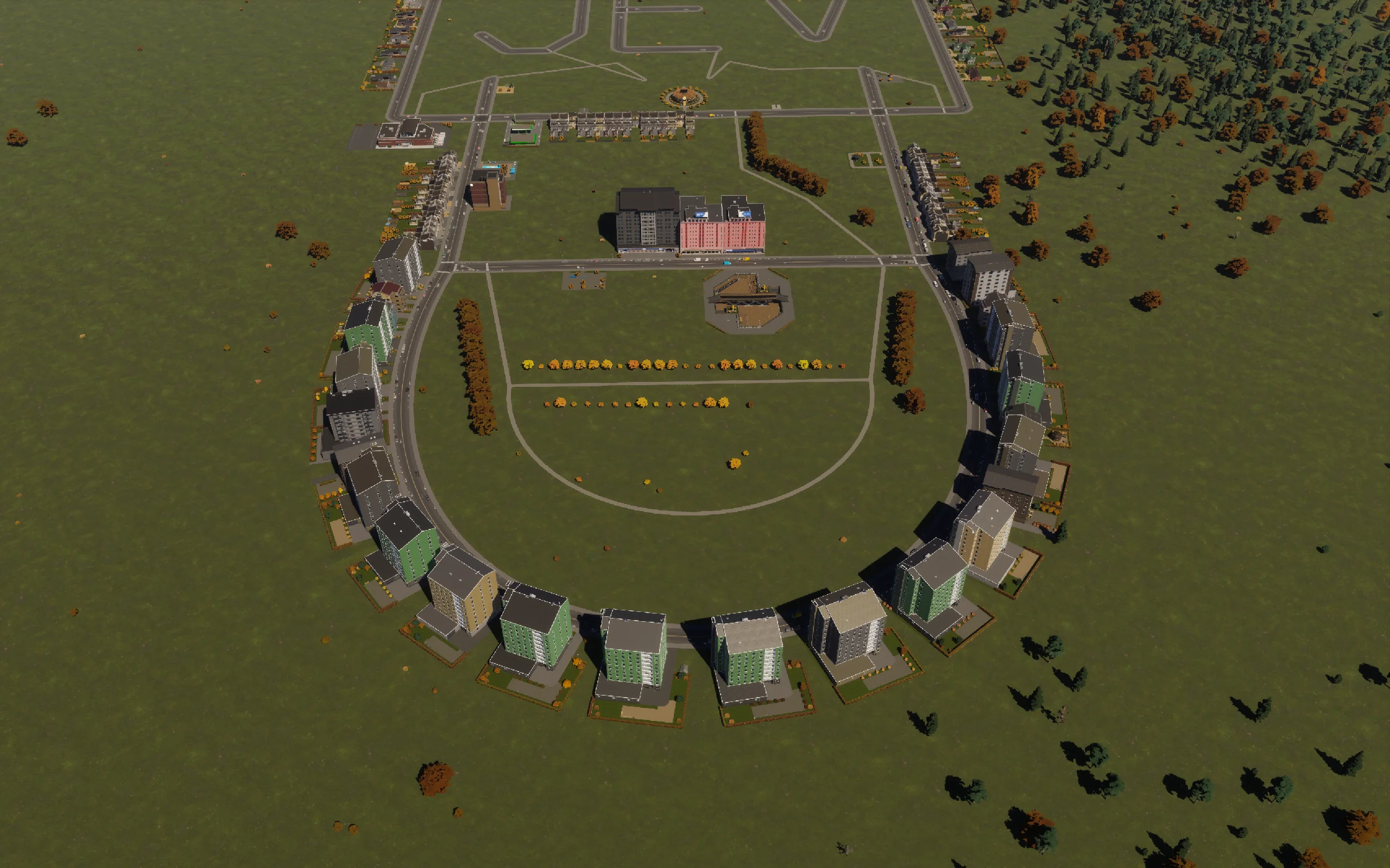 Completed apartment frontage around the sunken plaza, orchard rows and walking circuit.