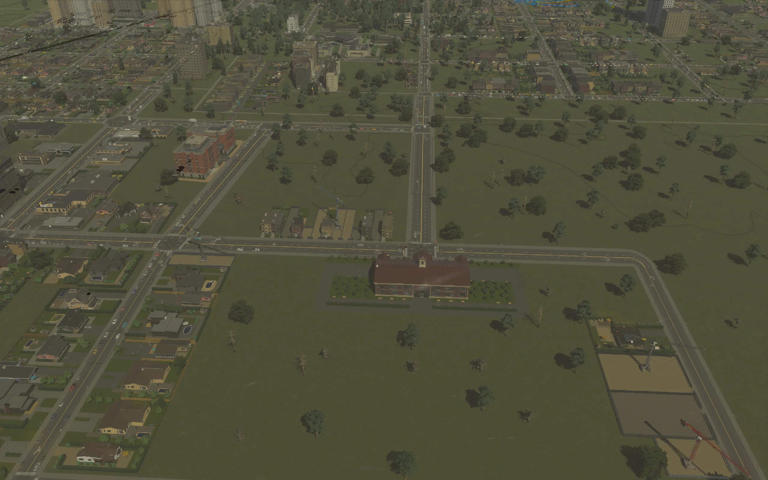 The western school and first homes during construction; this is an early progress photograph, not the opening city.